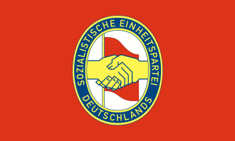 The red flag of the SED bears the SED logo, which portrays the handshake between Communist Wilhelm Pieck and Social Democrat Otto Grotewohl when their parties merged in 1946.