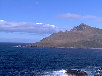 Cape Horn, seen from the Chilean Navy station location. The small lighthouse can be seen as a white spot close to the horizon.
