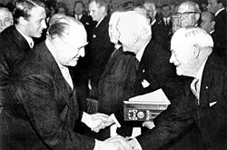 Peace Nobel Prize ceremony in 1963. From left to right: Crown Prince Harald of Norway, King Olav of Norway, ICRC president Leopold Boissier, League Chairman John A. MacAulay.