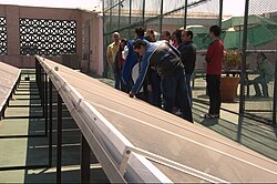 Participants in a workshop on sustainable development inspect solar panels at Monterrey Institute of Technology and Higher Education, Mexico City on top of a building on campus.