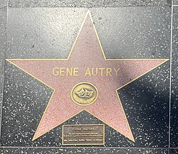 Gene Autry live theater star with a rectangular plaque below it that reads: GENE AUTRY / The only individual honored with a star in all five categories of the Hollywood Walk of Fame / Radio · Motion Pictures · Recording · Television · Live Performance