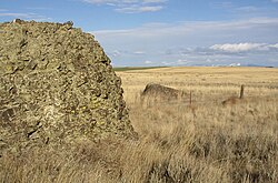 Example of mixed erratics. The boulder in the foreground is basalt. The boulder on the other side of the fence is granite.