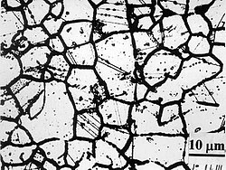 Sensitized metallic microstructure, showing wider intergranular boundaries