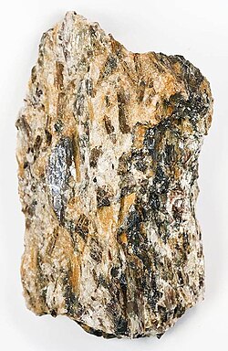 Schist is a metamorphic rock characterized by an abundance of platy minerals. In this example, the rock has prominent sillimanite porphyroblasts as large as 3 cm (1.2 in).