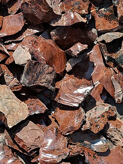 Spall from the knapping of obsidian (as by Native Americans) to form arrowheads and other tools. These unique obsidians occur at Glass Buttes, Oregon.