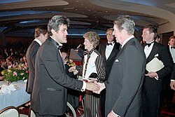 Leno shaking hands with president Ronald Reagan in April 1987
