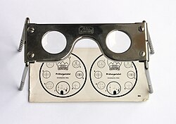Pocket stereoscope with original test image. Used by military to examine stereoscopic pairs of aerial photographs.