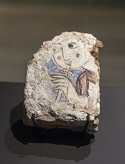 Fragment of the dome of the palace of ibn Mardanīsh in Murcia displaying a female figure playing a wind instrument, the mizmar.[158]