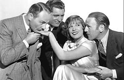 With Roland Young (right), Lili Damita (center), and Charlie Ruggles (far left) in his debut film This is the Night (1932)