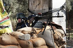 A Ba'athist Syrian Army soldier manning a checkpoint outside of Damascus shortly after the outbreak of the Syrian civil war, 2012
