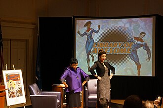 Librarian Carla Hayden (left) and Lynda Carter participating in the June 2017 "Library of Awesome" event at the United States Library of Congress that celebrated the role of comics and graphic novels in promoting literacy, as they strike the typical pose of Wonder Woman