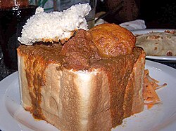 An example of bunny chow served in Durban, originated in the Indian South African community.[60]