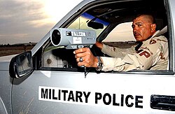 U.S. Military Police using a radar gun, an application of Doppler radar, to catch speeding violators