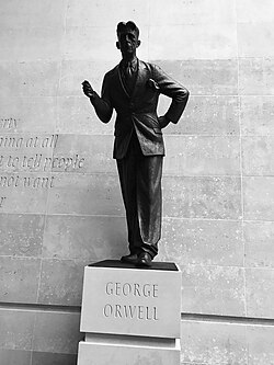 George Orwell statue at the headquarters of the BBC. A defence of free speech in an open society, the wall behind the statue is inscribed with the words "If liberty means anything at all, it means the right to tell people what they do not want to hear", words from George Orwell's proposed preface to Animal Farm (1945).[32]