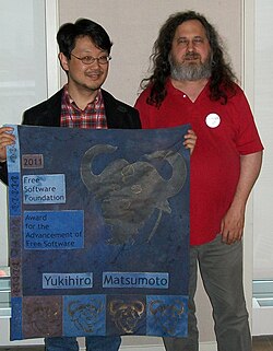 Matsumoto accepting an award from the Free Software Foundation (founder Richard Stallman, right) in 2012