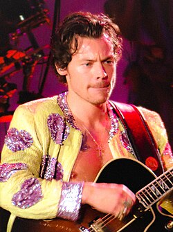 Harry Styles with a guitar