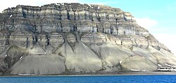 Talus cones on the north shore of Isfjorden, Svalbard, Norway. Talus cones are accumulations of coarse hillslope debris at the foot of the slopes producing the material.