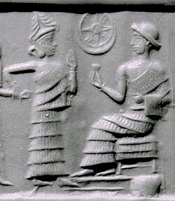 Sealing depicting the Neo Sumerian King, Ibbi-Sin seated with a star or Dingir and crescent adjacent to him