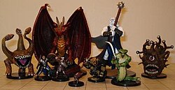 Dungeons & Dragons miniature figures. The grid mat underneath uses one-inch squares, with the side length of each square usually representing either 5 or 10 feet (1.5 or 3.0 m).