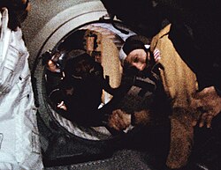 American Stafford and Russian Leonov shake hands in space aboard the Apollo–Soyuz docking adapter.