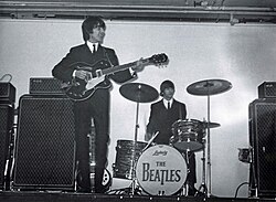 Harrison (left) and Ringo Starr (right) performing at the King's Hall in Belfast, 1964