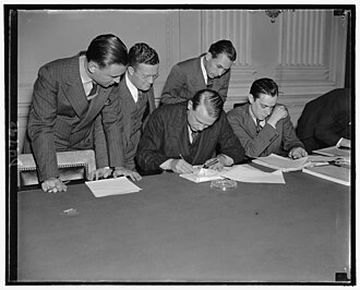 While newsmen take notes, Chairman Martin Dies Jr. of the House Un-American Activities Committee reads and proofs his letter replying to Pres. Roosevelt's attack on the committee, October 26, 1938