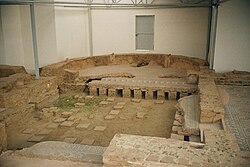 Ruins of the hypocaust under the floor of a Roman villa. The part under the exedra is covered.