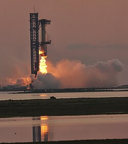 Booster 12 is successfully caught by the launch tower during flight test 5.