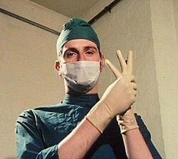 Adams in his first Monty Python appearance, in surgeon's garb