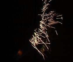 Color-changing sparks from erbium powder with golden and green spark phases.