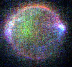 Auroral glows in Io's upper atmosphere. Different colors represent emission from different components of the atmosphere (green comes from emitting sodium, red from emitting oxygen, and blue from emitting volcanic gases like sulfur dioxide). Image taken while Io was in eclipse.