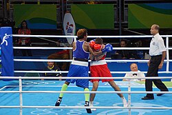 Boxer (left) using Arm-in hug against boxer (right) using High Guard