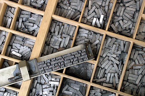 Movable type on a composing stick on a type case
