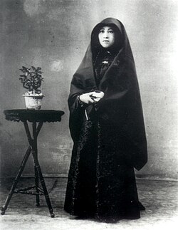 A Macanese senhora in her traditional attire, the dó, early 20th century