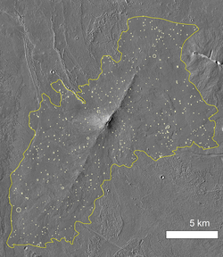 Shield volcano in Tharsis region on Mars with marked borders, circles represent impact craters counted by crater counting method.