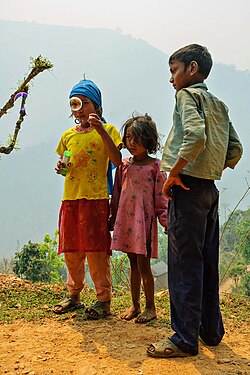 Soap bubbles watched by children exploring a bubble blower, Dhading, Nepal