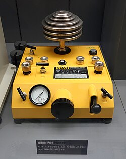 Dead-weight tester. This uses known calibrated weights on a piston to generate a known pressure.