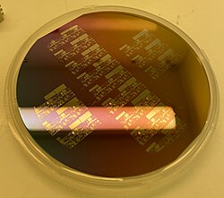 Silicon wafer which has been thermally oxidized using water vapor at 1100º C for ~30 nm of silicon dioxide. The clear regions have been etched bare for subsequent doping.