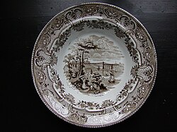A Staffordshire pottery stoneware plate from the 1850s with white glaze and transfer printed design. Visually this hardly differs from earthenware or porcelain equivalents.