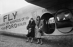 Two women standing at the door of a Trimotor at Washington National Airport in 1930