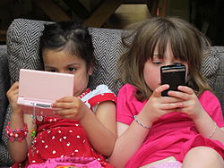 Two children on their electronic devices (2011)