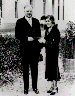 Mary Pickford giving President Herbert Hoover a ticket for a film industry benefit for the unemployed, 1931