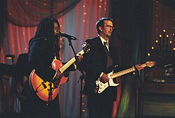Chapman and Eric Clapton on stage at a White House Special Olympics dinner, December 1998