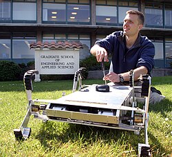 An agricultural and biosystems engineer fixing an agricultural robot