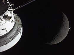 Photograph of the Moon, along with Earth during Earthset and the capsule Integrity, from cislunar space during the crewed Artemis II lunar flyby in 2026, the first crewed circumlunar flight since 1972
