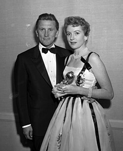Best actress winner Kerr, alongside the best actor winner Kirk Douglas at the 14th Golden Globe Awards in 1957