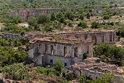 Overgrown rubble and ruined buildings in Aghdam