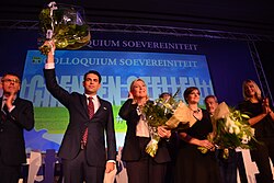 Tom Van Grieken (Vlaams Belang) on stage with French far-right politician Marine Le Pen during a convention in 2015.