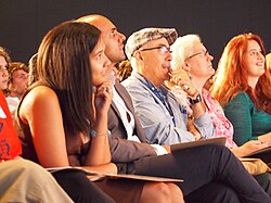 Judges from a poetry slam listen to the contestants.