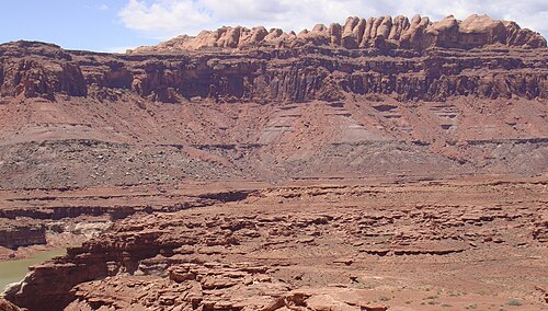 The Permian through Jurassic stratigraphy of the Colorado Plateau area of southeastern Utah is an example of both original horizontality and the law of superposition. These strata make up much of the famous prominent rock formations in widely spaced protected areas such as Capitol Reef National Park and Canyonlands National Park. From top to bottom: Rounded tan domes of the Navajo Sandstone; layered red Kayenta Formation; cliff-forming, vertically jointed, red Wingate Sandstone; slope-forming, purplish Chinle Formation; layered, lighter-red Moenkopi Formation; and white, layered Cutler Formation sandstone. Picture from Glen Canyon National Recreation Area, Utah.